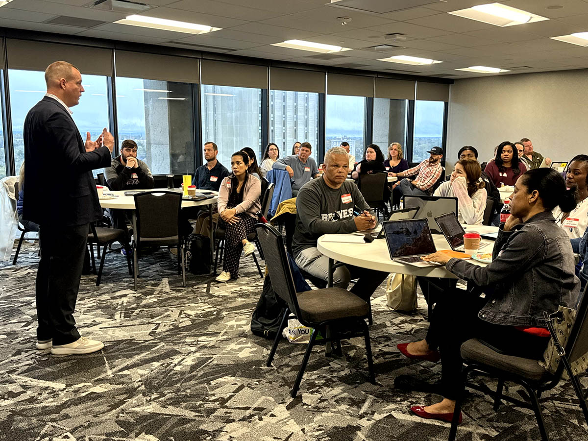 Man addressing full conference room