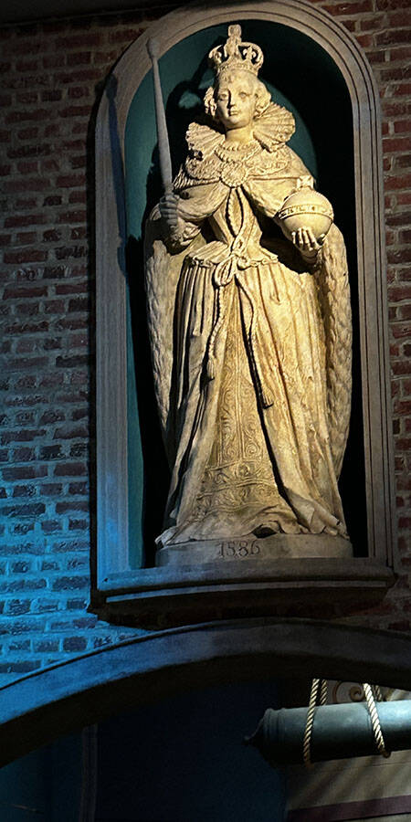 stone statue set in an alcove in a brick wall