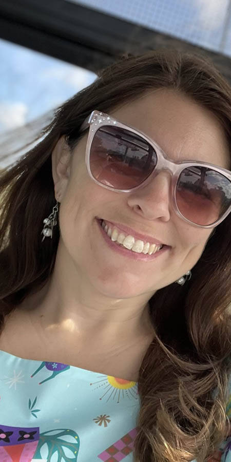 Brown-haired white woman wearing sunglasses