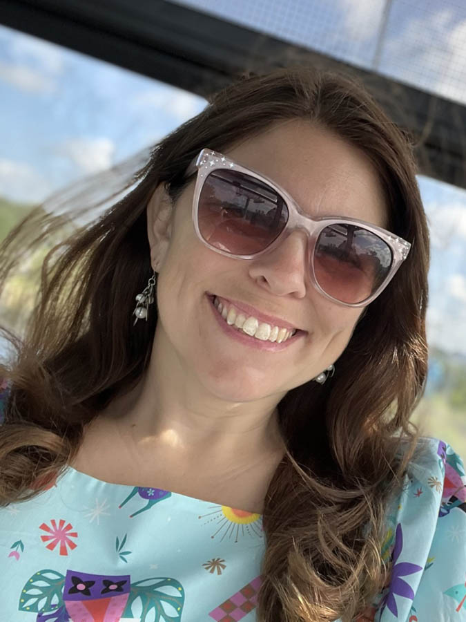 Brown-haired white woman wearing sunglasses