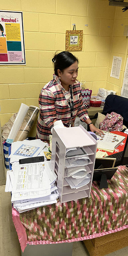 Teacher in plaid dress in classroom