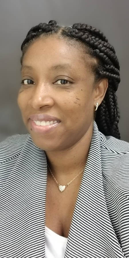 Black woman with braided hair in a striped gray suit.