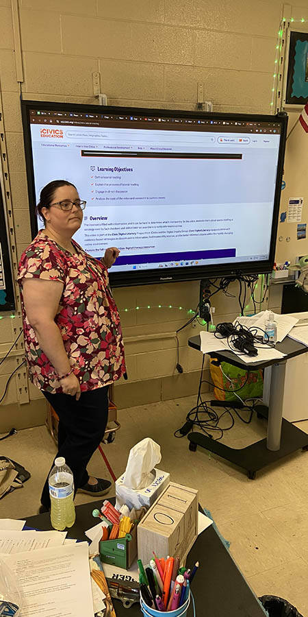 Teacher standing in front of a display screen