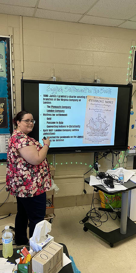 Teacher standing in front of a display screen