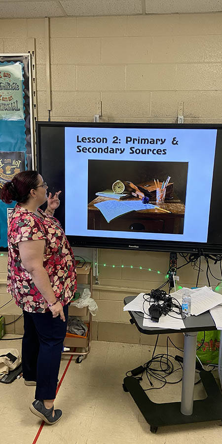 Teacher standing in front of a display screen