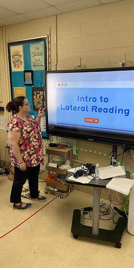 Teacher standing in front of a display screen