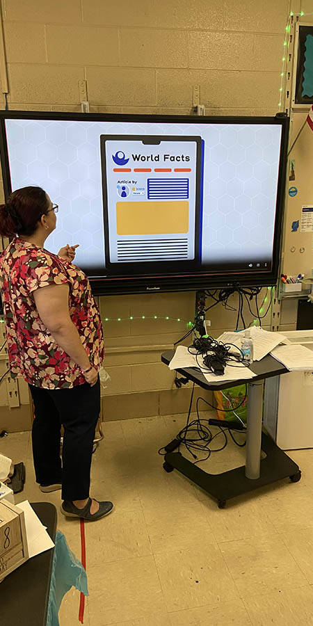 Teacher standing in front of a display screen
