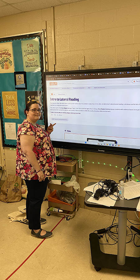 Teacher standing in front of a display screen