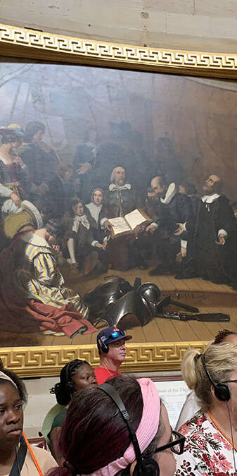 People in a room with a painting.